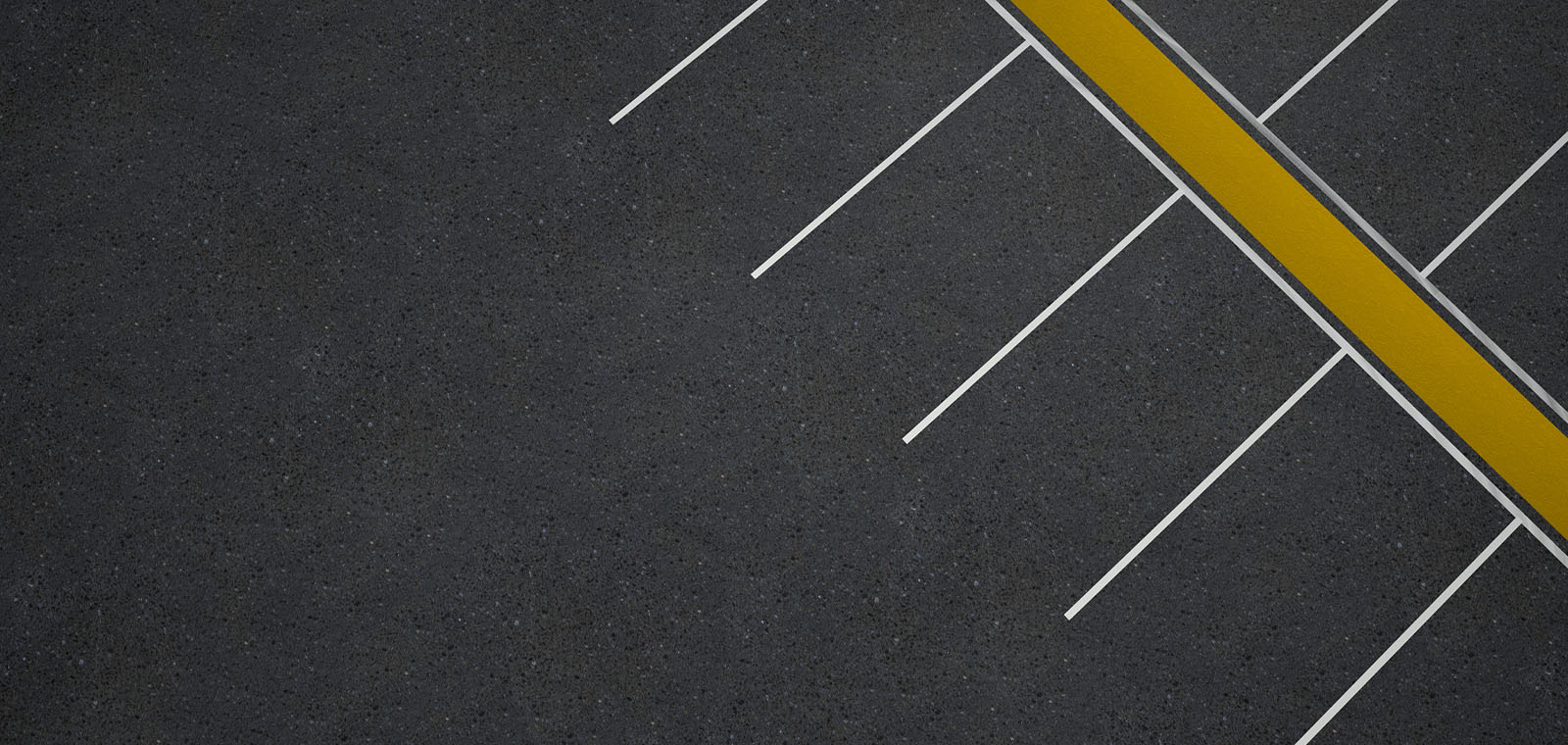 Lines in an empty parking lot appear as markings on a ruler.